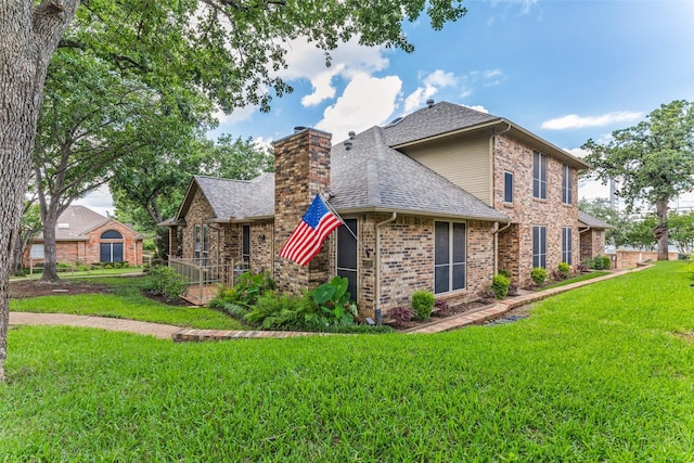 1230 Wooded Trl, Hurst, TX 76053 - back of property featuring a yard, a shingled roof, a chimney, and brick siding