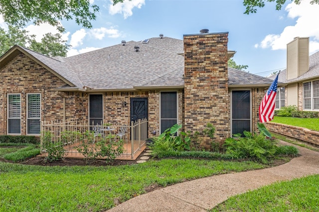 1230 Wooded Trl, Hurst, TX 76053 - back of house featuring roof with shingles, brick siding, a lawn, and a chimney