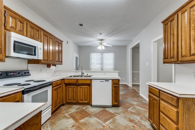 1230 Wooded Trl, Hurst, TX 76053 - kitchen with white appliances, a sink, brown cabinets, light stone finish floors, and a peninsula