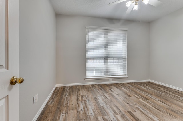 1230 Wooded Trl, Hurst, TX 76053 - empty room with a ceiling fan, wood finished floors, healthy amount of natural light, and baseboards