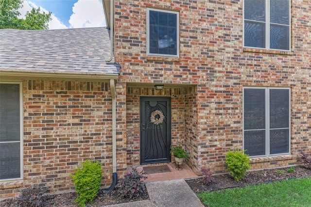 1230 Wooded Trl, Hurst, TX 76053 - doorway to property featuring brick siding and a shingled roof