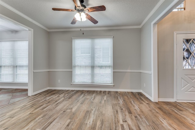 1230 Wooded Trl, Hurst, TX 76053 - entryway with a textured ceiling, a ceiling fan, wood finished floors, healthy amount of natural light, and baseboards