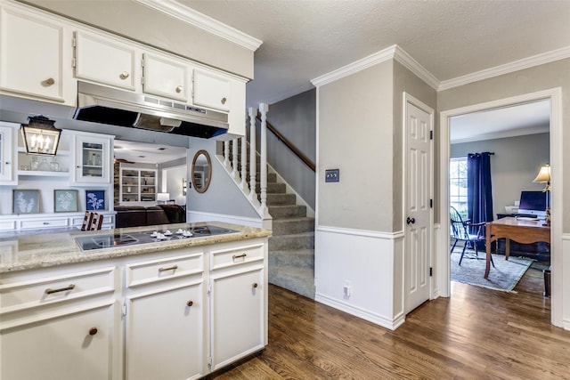 kitchen featuring white cabinetry, dark hardwood / wood-style flooring, ornamental molding, and black electric cooktop