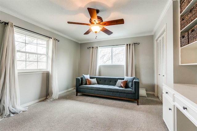 living area featuring ornamental molding, light carpet, and ceiling fan