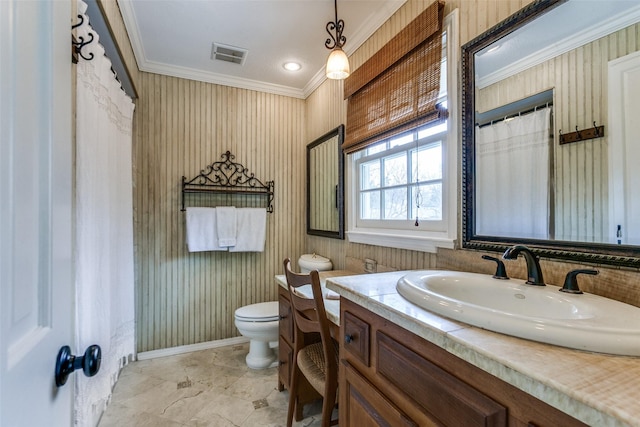 bathroom with vanity, crown molding, and toilet