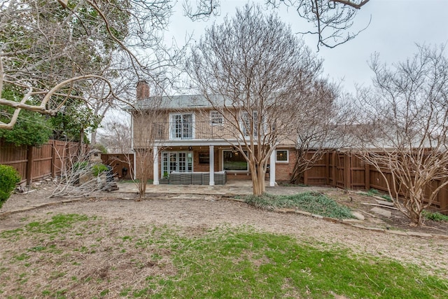 rear view of property featuring a patio area