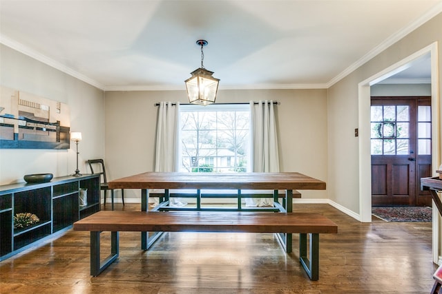 dining space with a notable chandelier, crown molding, and dark wood-type flooring