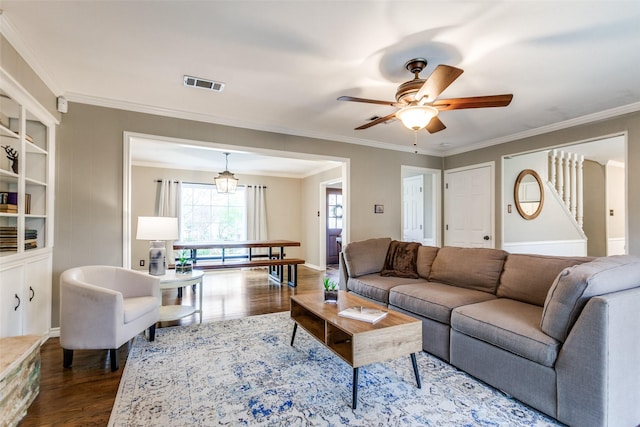 living room featuring hardwood / wood-style flooring, ceiling fan, and crown molding