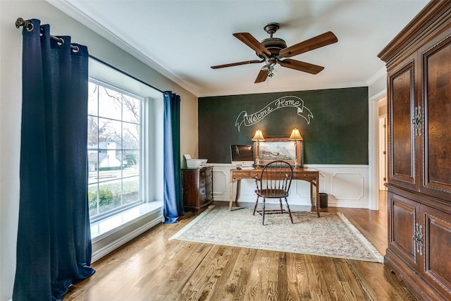 interior space with ornamental molding, a healthy amount of sunlight, ceiling fan, and light hardwood / wood-style flooring