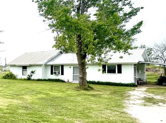 back of house with a lawn