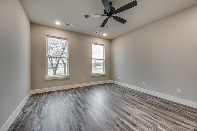 empty room with dark wood-type flooring and ceiling fan