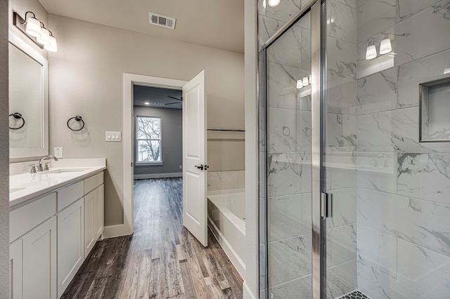 bathroom featuring independent shower and bath, vanity, and hardwood / wood-style floors