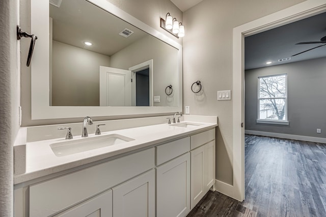 bathroom with vanity, hardwood / wood-style flooring, and ceiling fan