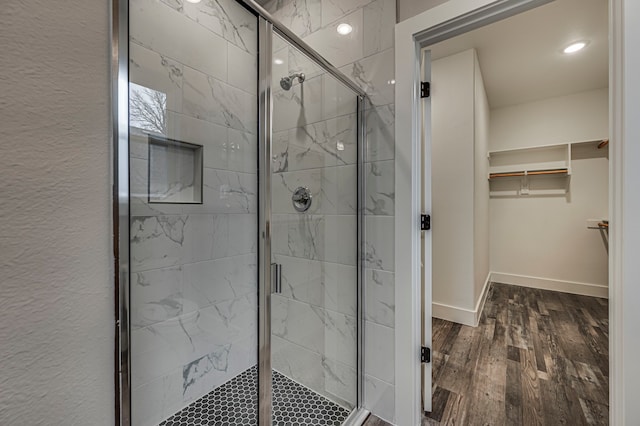 bathroom featuring hardwood / wood-style floors and a shower with shower door