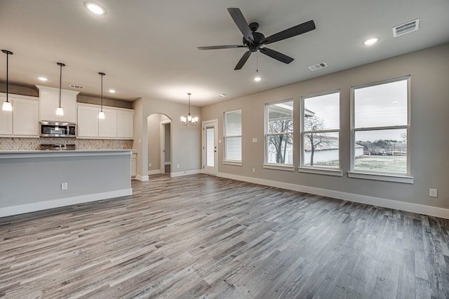 unfurnished living room with light hardwood / wood-style floors and ceiling fan