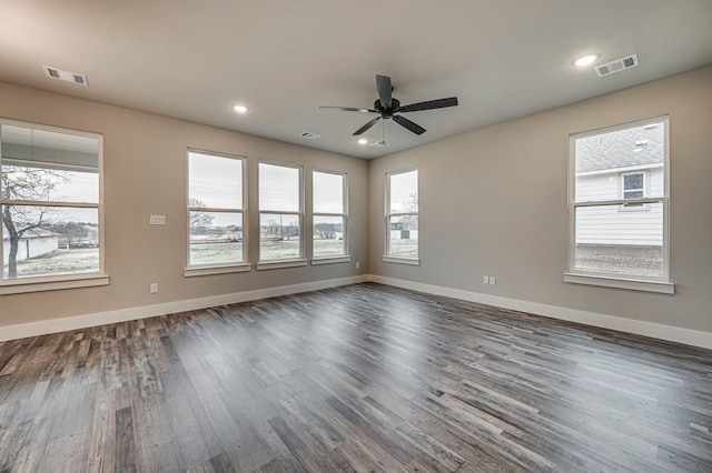 spare room featuring dark hardwood / wood-style floors and ceiling fan