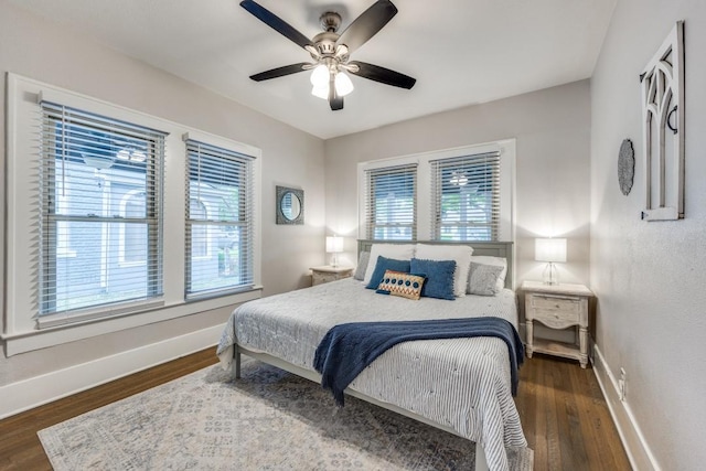 bedroom featuring baseboards, a ceiling fan, and wood finished floors