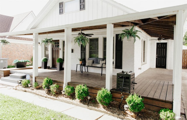 wooden terrace with a porch and ceiling fan