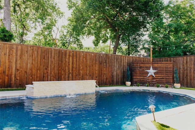 view of swimming pool with pool water feature