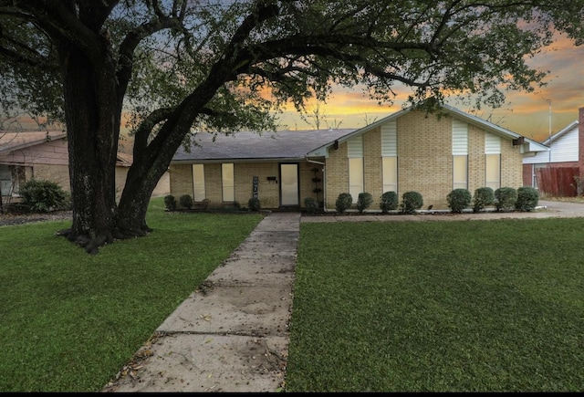 ranch-style house with a yard