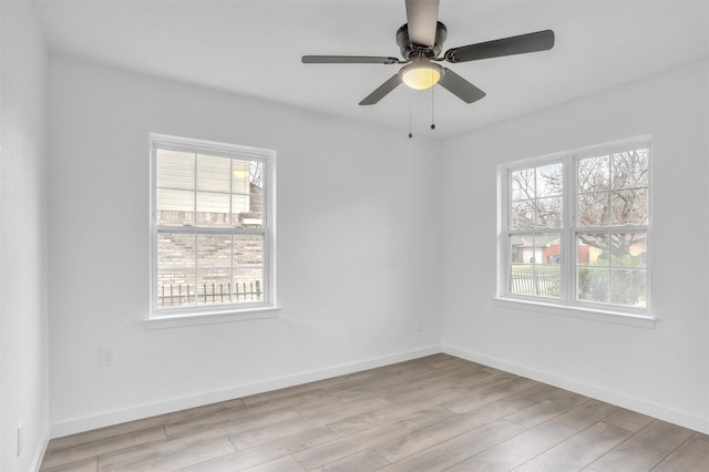 unfurnished room with ceiling fan and light wood-type flooring