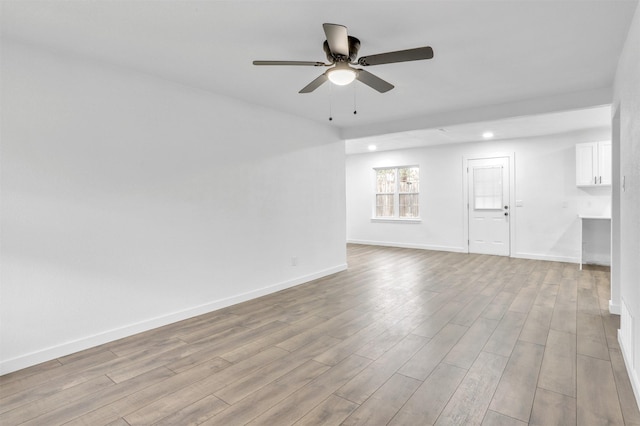 empty room featuring ceiling fan and light wood-type flooring