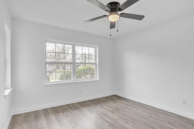 empty room featuring ceiling fan and light hardwood / wood-style flooring