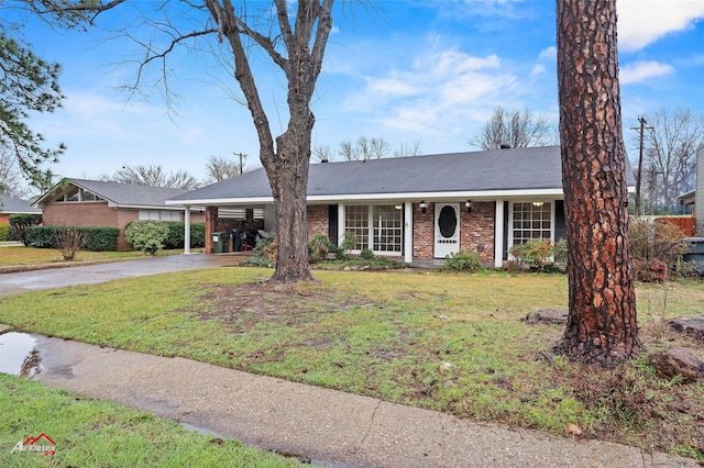 ranch-style home with a carport and a front yard