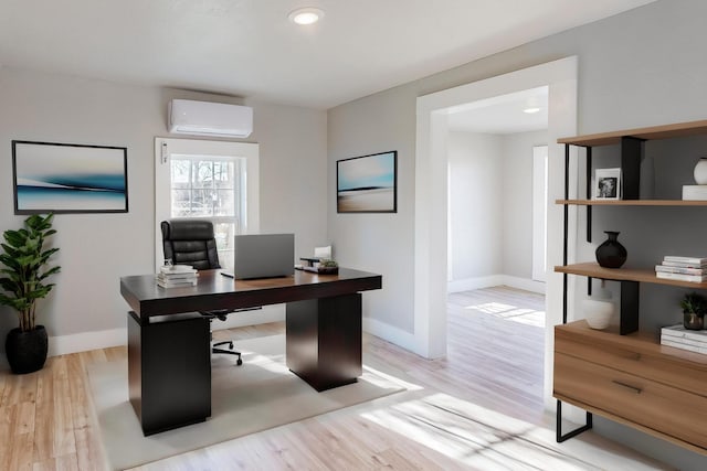 office area featuring an AC wall unit and light wood-type flooring