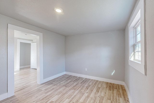 unfurnished room with light wood-type flooring