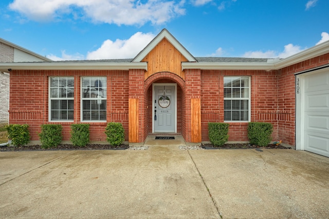 doorway to property with a garage