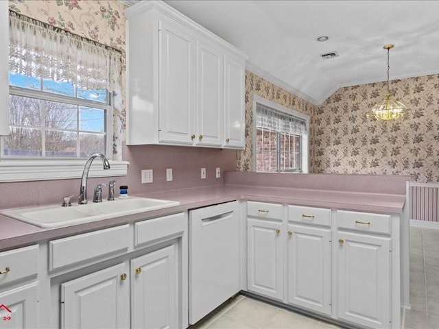 kitchen featuring sink, white cabinetry, decorative light fixtures, vaulted ceiling, and dishwasher