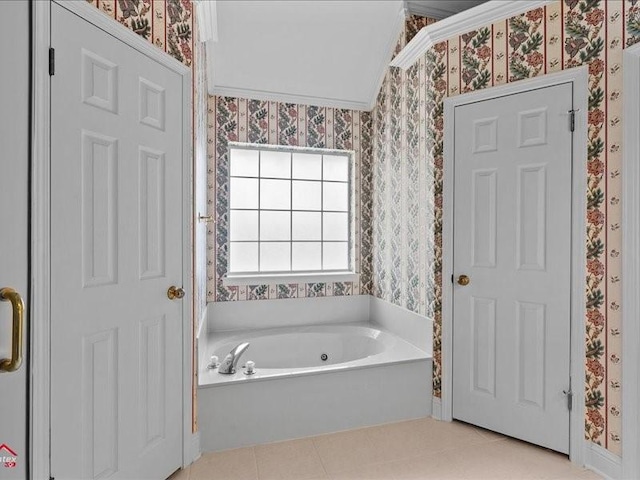 bathroom with a bath, crown molding, and tile patterned floors