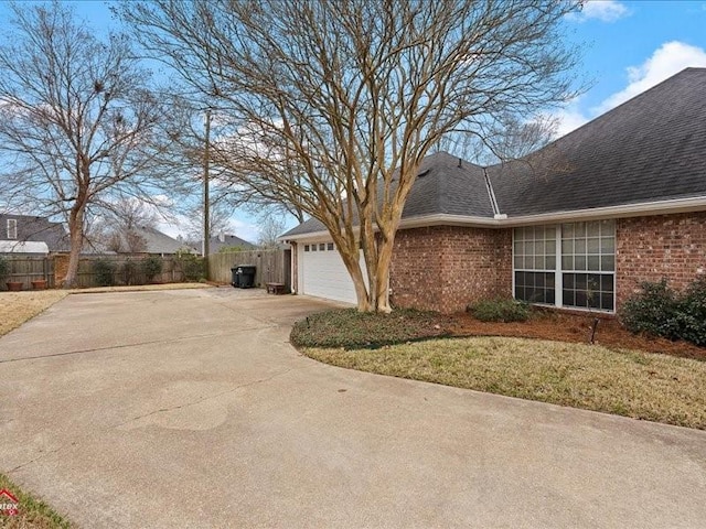 view of home's exterior with a garage and a yard