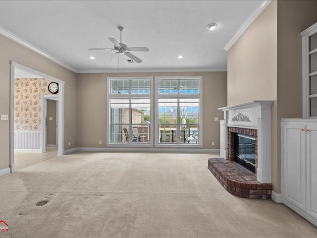 unfurnished living room featuring crown molding, a fireplace, light colored carpet, and ceiling fan