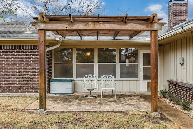 back of property featuring a pergola and a patio