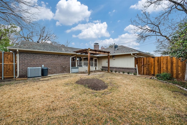 rear view of house featuring cooling unit, a pergola, and a lawn