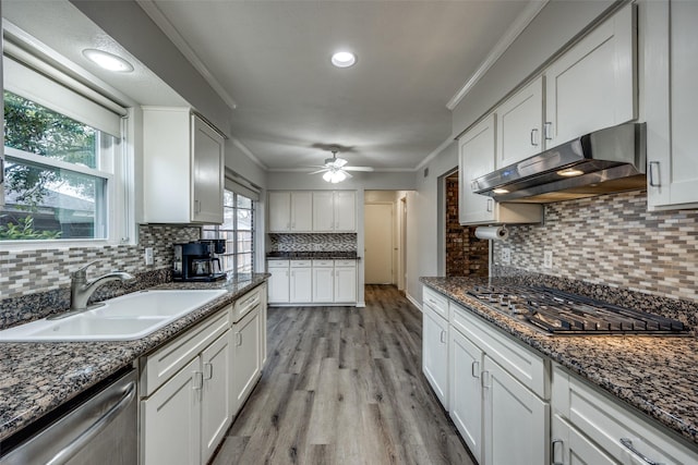 kitchen featuring white cabinetry, ornamental molding, stainless steel appliances, and sink