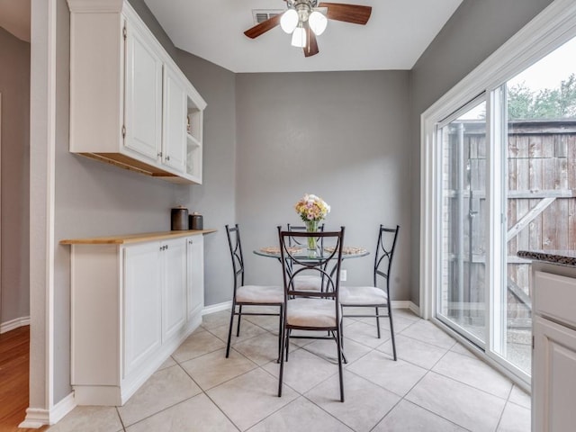 dining area with ceiling fan and light tile patterned flooring