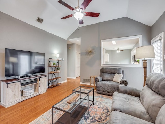 living room with wood-type flooring, lofted ceiling, and ceiling fan