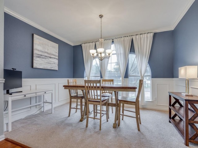 dining space with crown molding, light colored carpet, and a chandelier