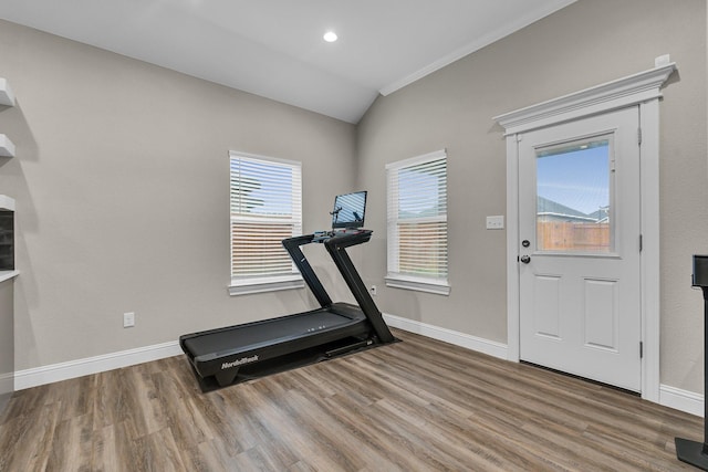 workout room featuring wood-type flooring and lofted ceiling