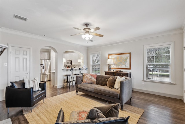 living room featuring ornamental molding, dark hardwood / wood-style floors, and ceiling fan