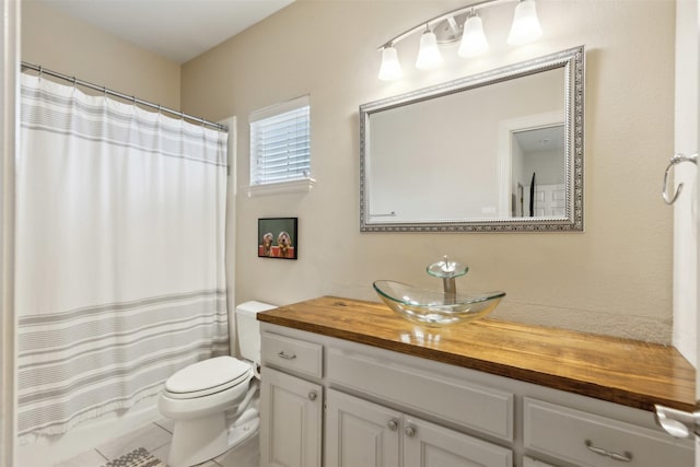 bathroom featuring vanity, tile patterned floors, and toilet