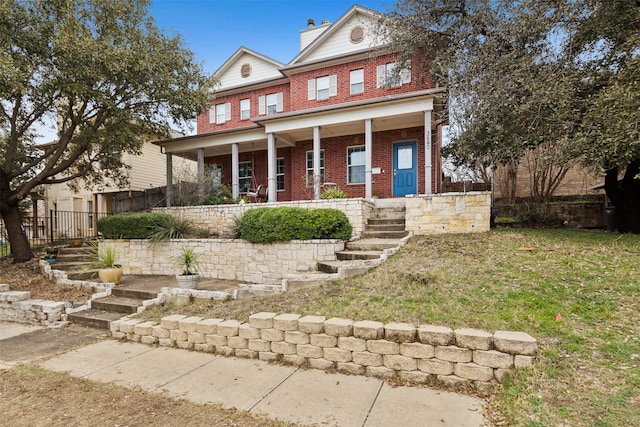 view of front of house featuring a porch and a front lawn