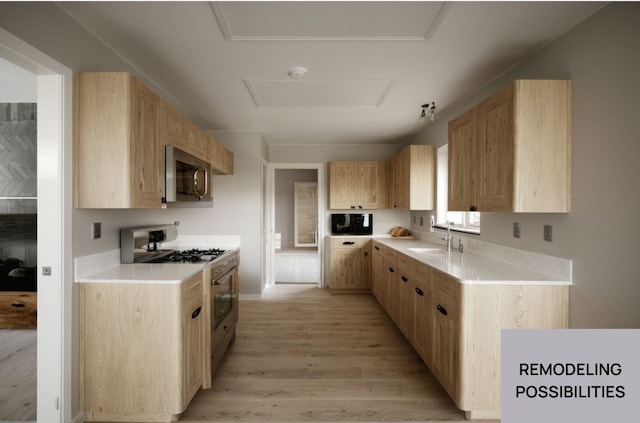 kitchen with a sink, appliances with stainless steel finishes, light wood finished floors, and light brown cabinets