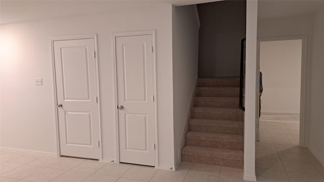 stairway featuring tile patterned flooring