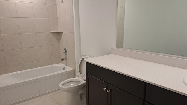 full bathroom featuring tile patterned flooring, vanity, tiled shower / bath combo, and toilet