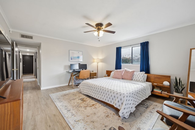 bedroom featuring crown molding, ceiling fan, and light wood-type flooring