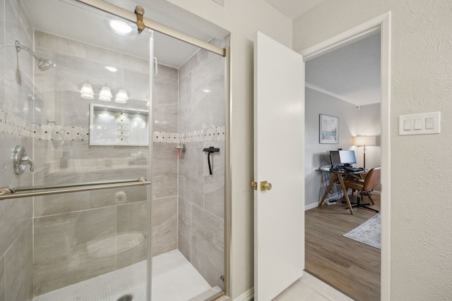 bathroom with walk in shower and hardwood / wood-style flooring